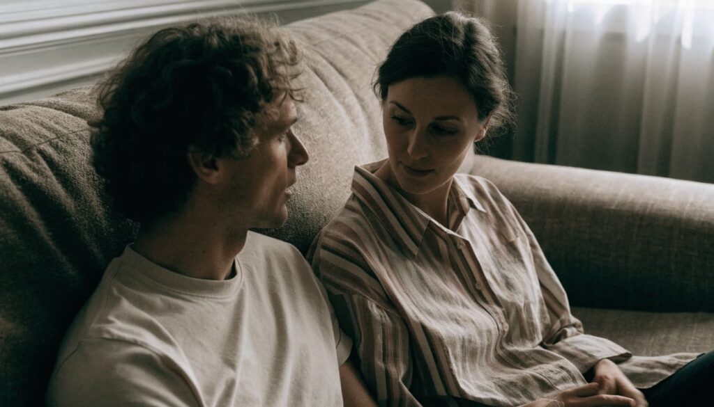 How to Set Boundaries With In-Laws: Scripts for Visits, Advice, and Privacy 2 Two adults talk privately in a living room.
