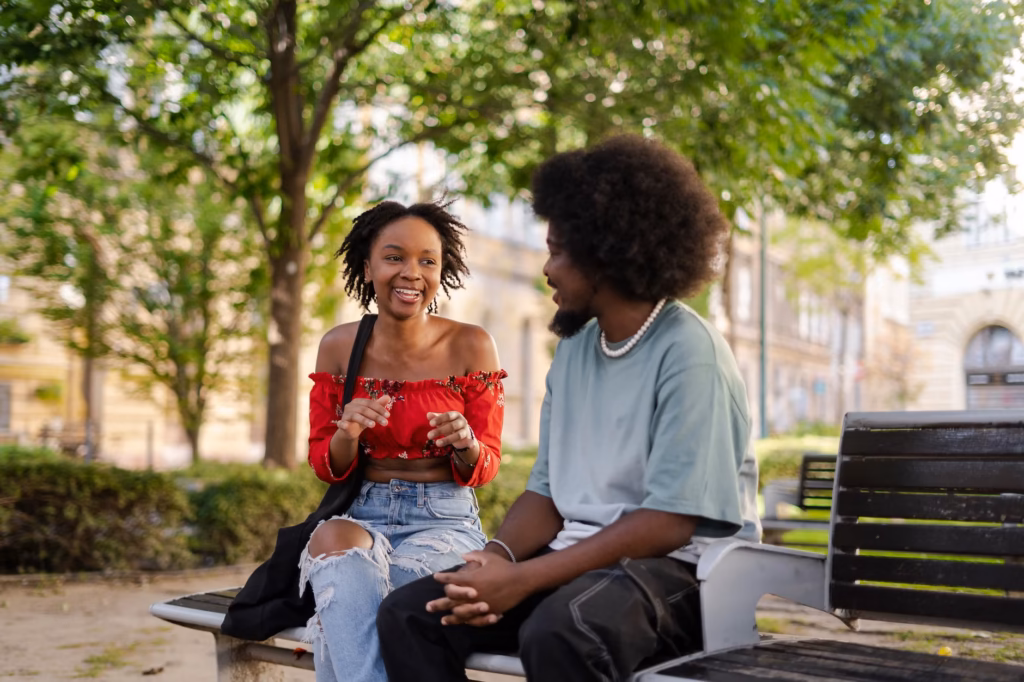 How to Improve Communication in a Relationship: Pause, Reflect, Clarify 4 A woman talks with a man on a park bench.